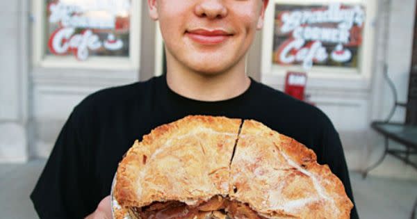 person with pie in front of Bradley's Corner Cafe