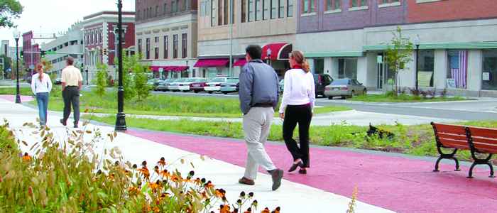 Couples walking on a downtown sidewalk