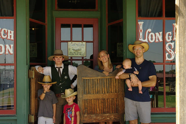 Dodge City Days Family of 5 standing outside of an old fashioned saloon