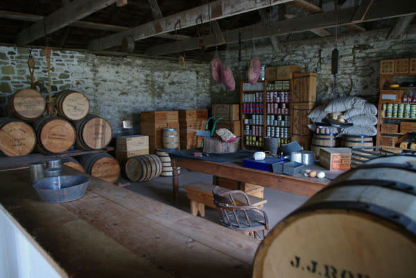 Old fashioned fort with stone walls and wooden tables.
