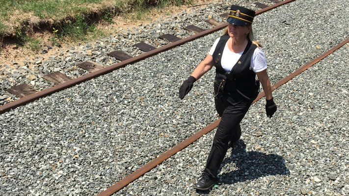 The conductor is in charge of the train, and Bonny Mallon takes the responsibility seriously.