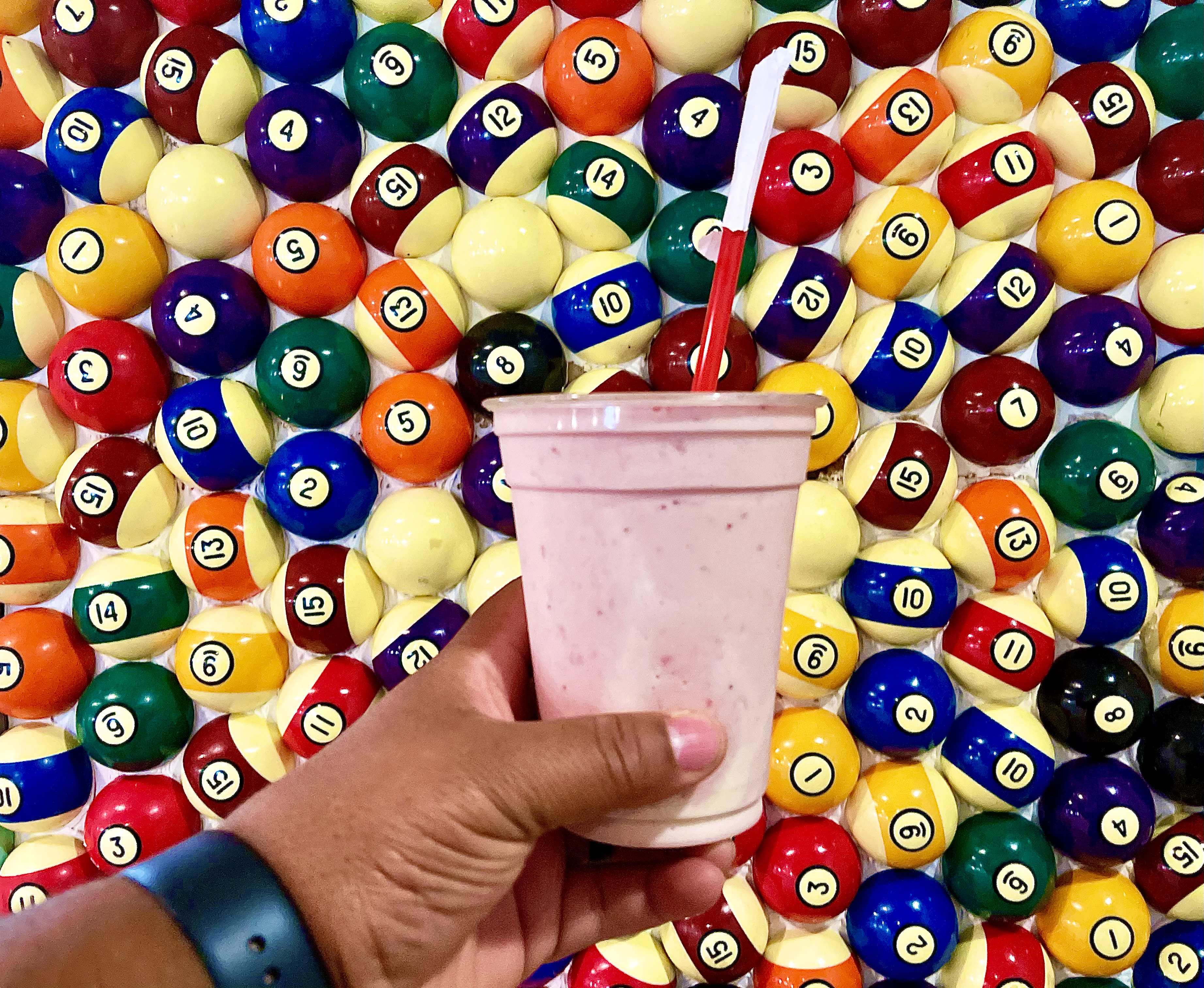 milkshake against wall of pool balls