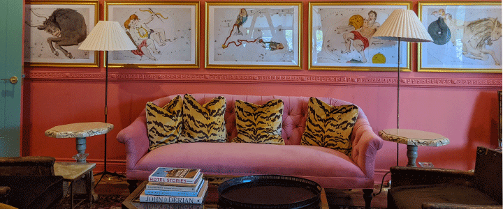 The Bradford House Living Room Area With Couch And Tiger Striped Pillows
