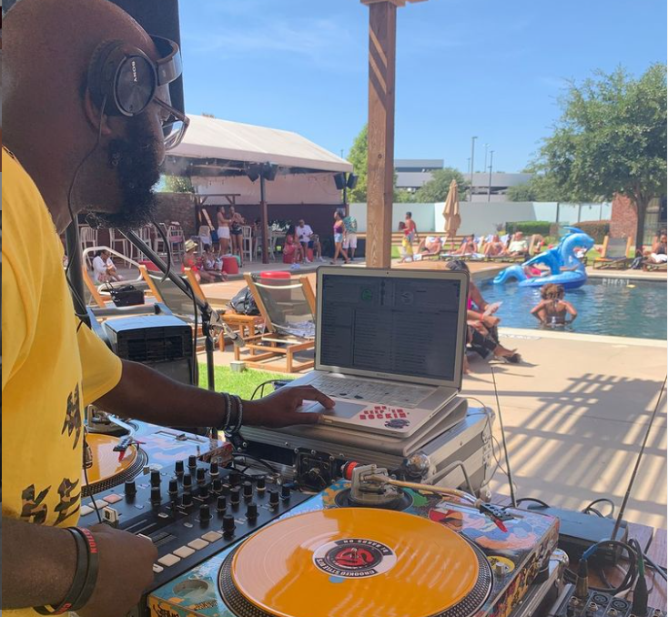 A DJ entertains poolside guests with music at The NYLO Las Colinas Hotel pool.