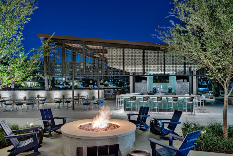 A firepit at night at the Lakehouse Waterfront Lounge in Irving, TX