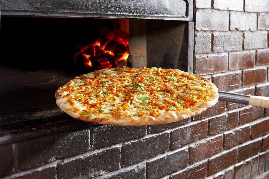 Pizza going into the oven at Grimaldi's at the Toyota Music Factory