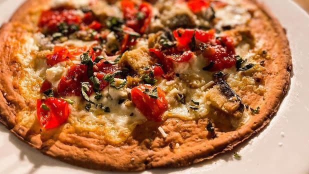Gluten-free pizza topped with roasted vegetables