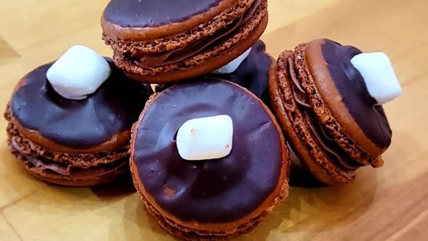 Chocolate macarons topped with chocolate glaze and mini marshmallow