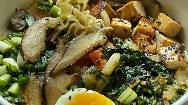 Pho bowl, filled with tofu, noodles, mushrooms, and assorted vegetables