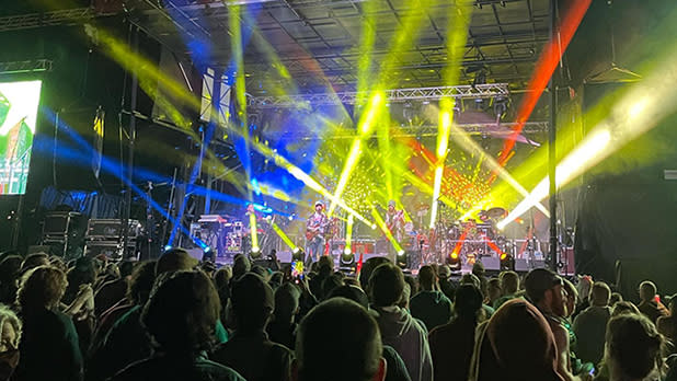 Colorful lights on a stage during a music festival.