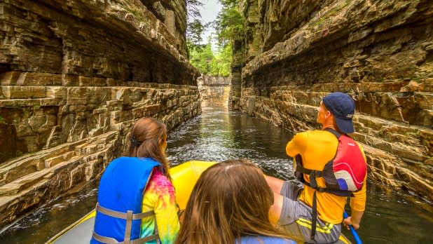 People navigating the waters of Ausable Chasm