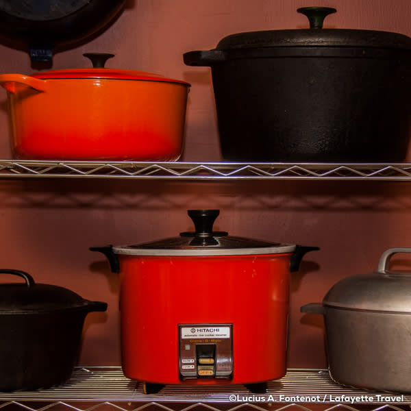 Red Hitachi Rice Cooker in pantry with other pots