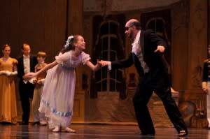 Clara and Herr Drosselmeyer dance in the Nutcracker