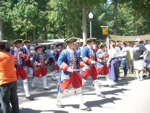 Drum & Fife Corps march through the festival grounds.