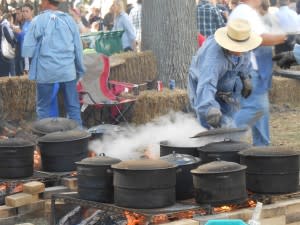 Mmm - smell the food cooking? These chefs use open fires and Dutch ovens to produce delectable dishes in the pioneer style. 