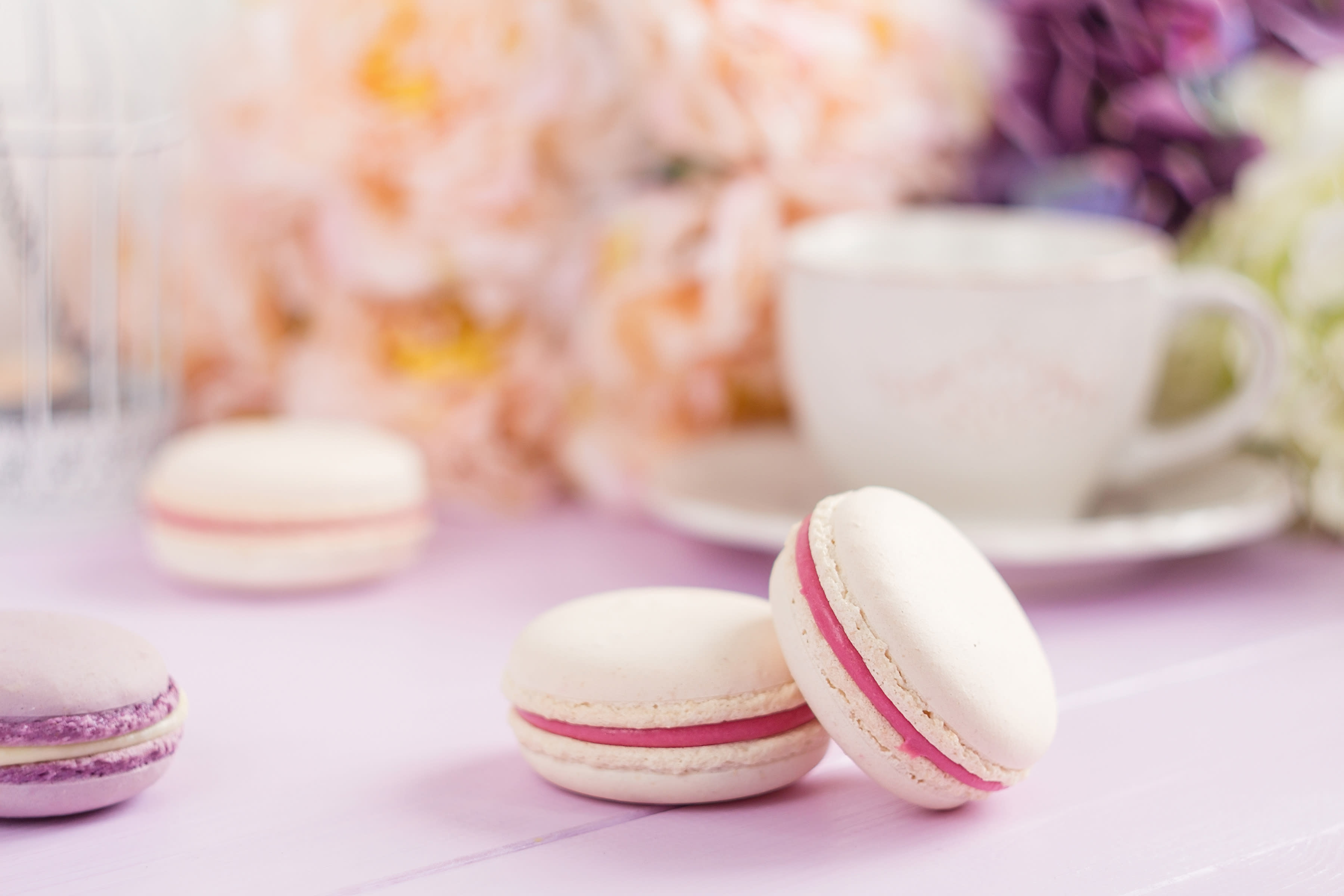Pastel colored macaroons with floral background