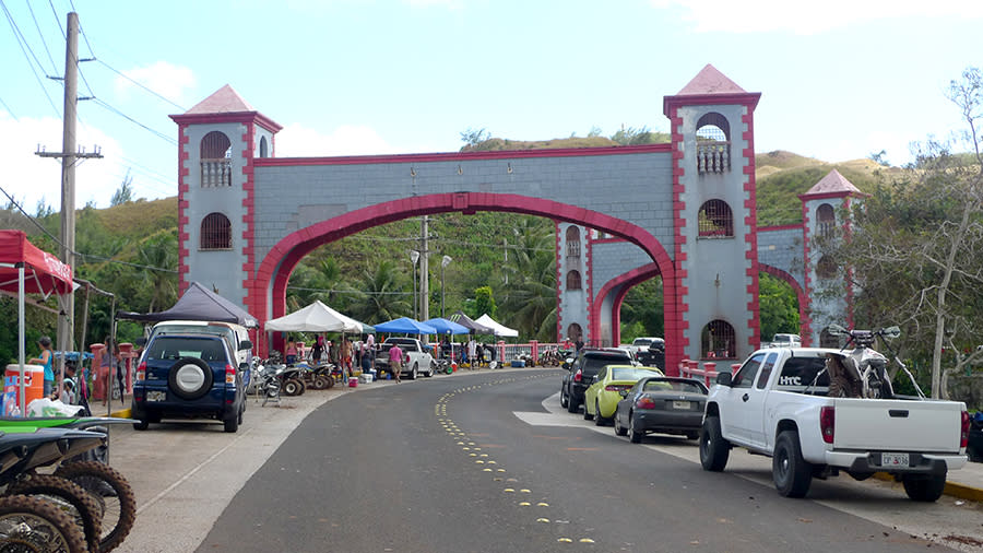 Cars fill the street at the Umatac Bridge during discovery Day