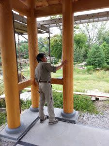 Japanese garden designer Sadafumi Uchiyama inspects progress at Wellfield Botanic Gardens' Island Garden.