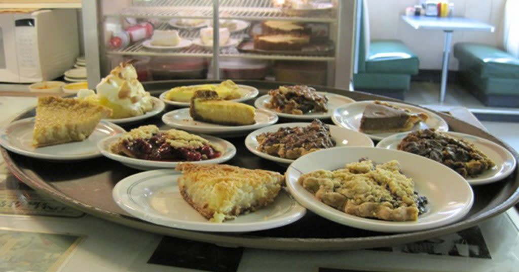 A tray of small white plates with assorted slices of pie from the South Side Soda Shop in Goshen, IN