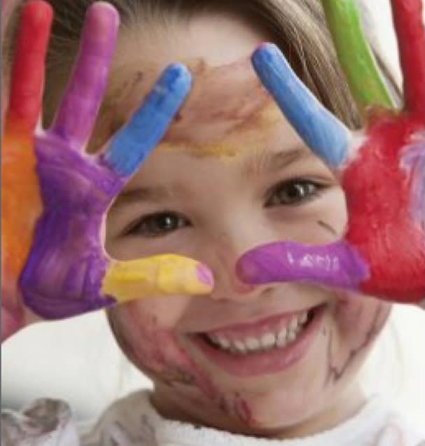 Toddler Power Hour Toddler holds up painted hands