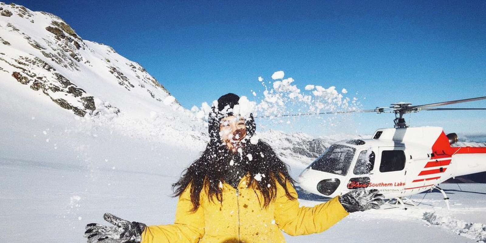 Lady playing in the snow. Glacier landing and snow experience