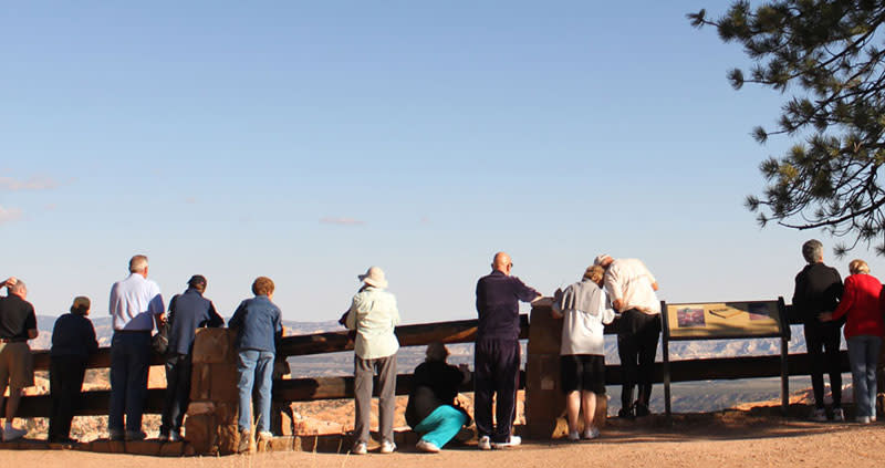 International visitors share the railing on the rim at Bryce Canyon