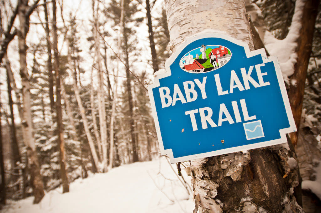 Sign for the Baby Lake Trail at the Al Quaal Recreation Area a skiing and hiking trail spot in Ishpeming Michigan.