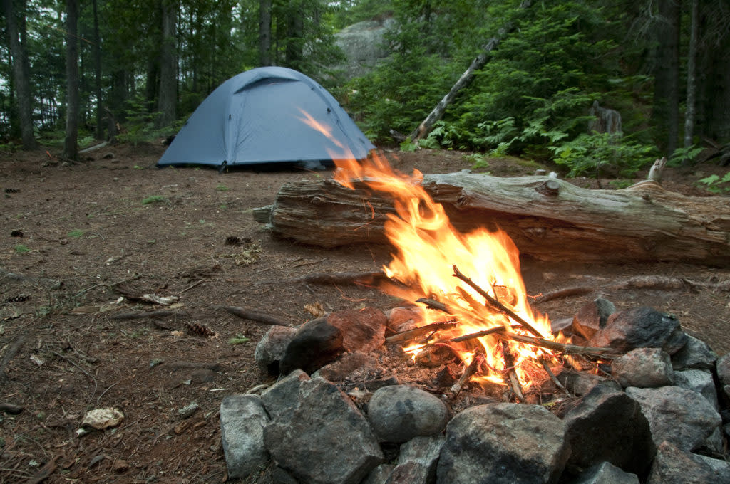 Camp fire at a remote canoe in campsite at Craig Lake State Park near Michigamme Michigan.