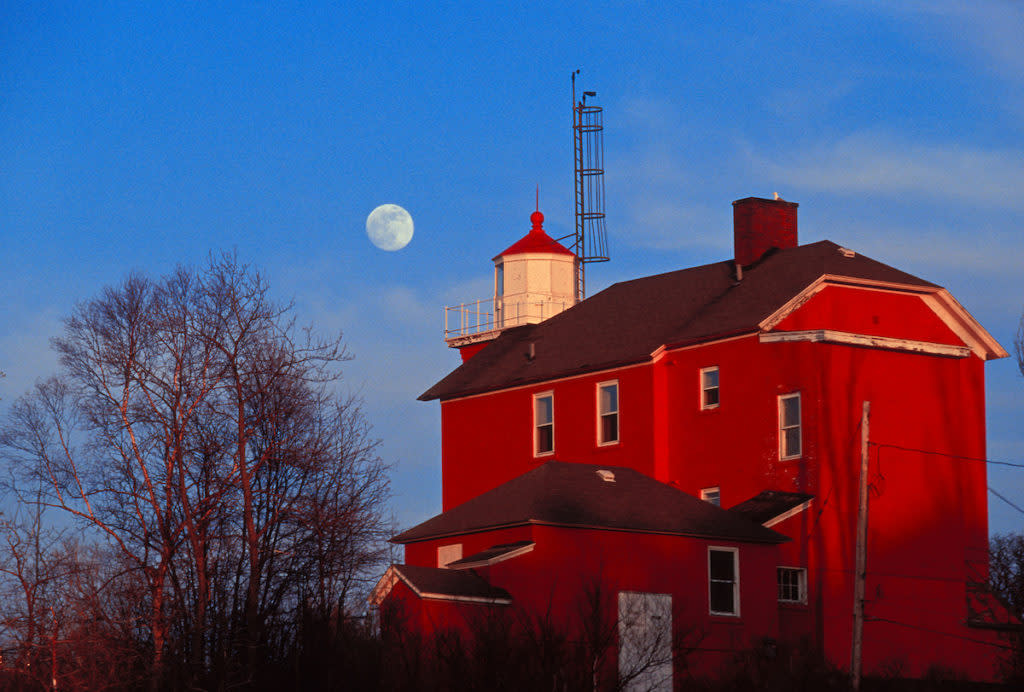 MARQUETTE LIGHTHOUSE ON LAKE SUPERIOR WITH FULL MOON IN MARQUETTE, MICHIGAN.