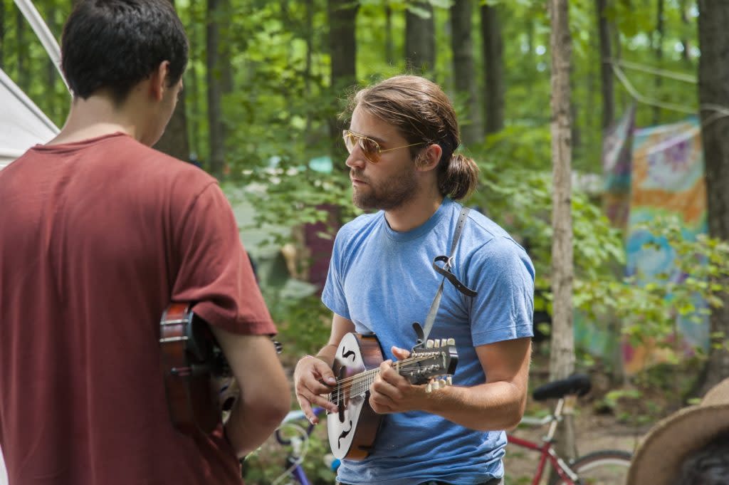 Peer to peer learning during an instrument workshop at Blissfest a Michigan music festival.