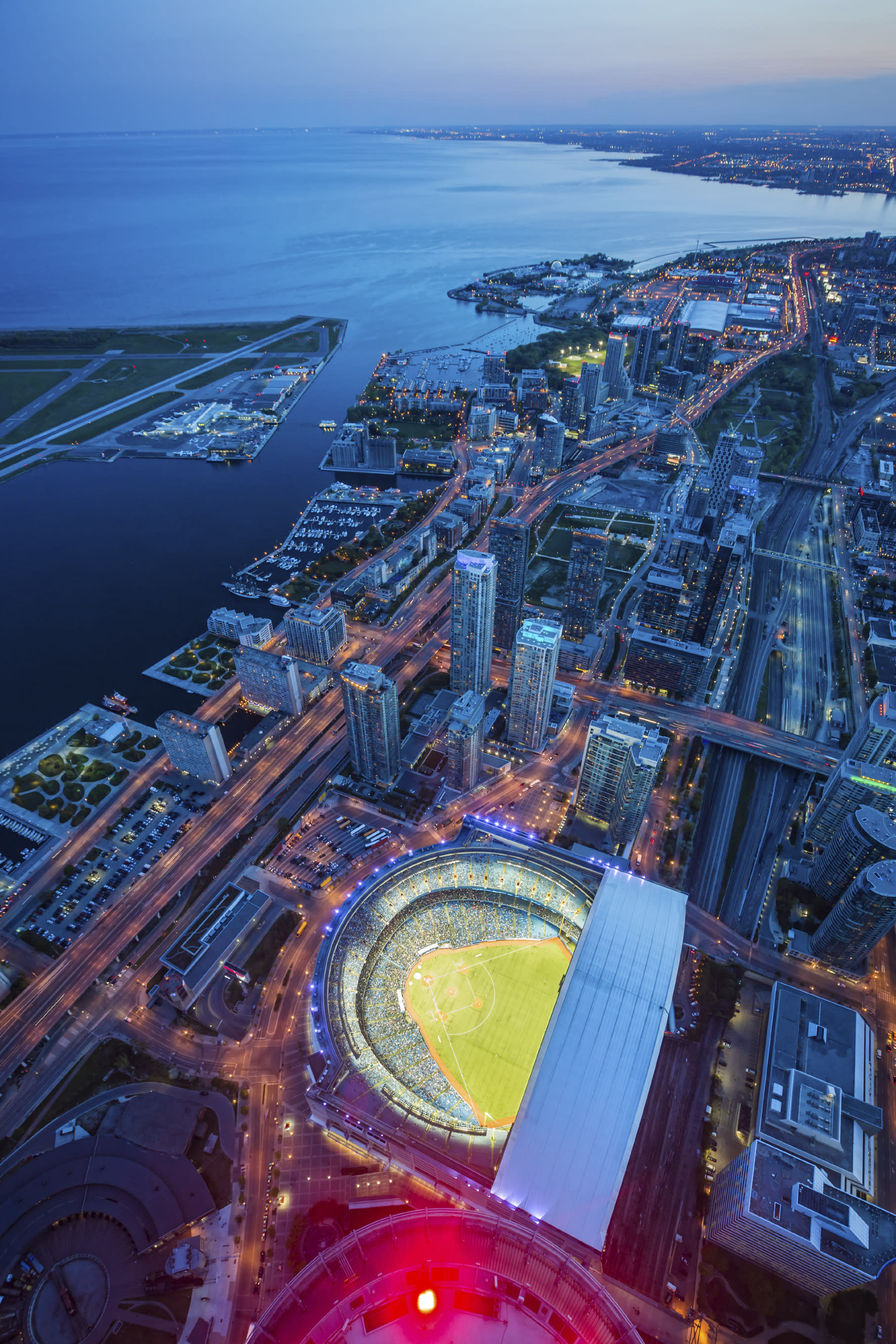 Toronto cityscape with baseball stadium at dusk