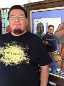 Painter Ryan Singer poses with his self-portrait.