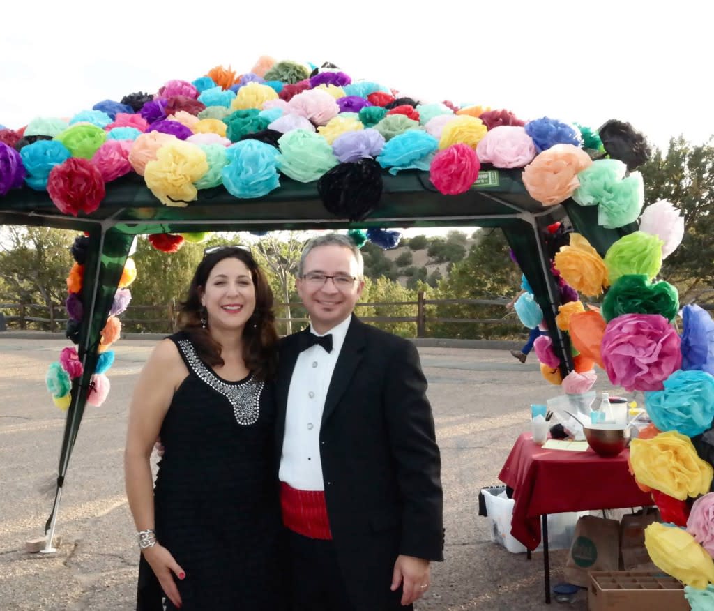 Committed tailgaters like Jennifer and Khristaan Villela dress up the dining canopy to complement the formal wear! (Photo Credit: Lara Nickel)