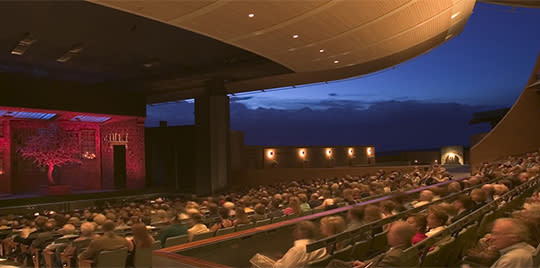 Santa Fe Opera goers enjoy a production in a striking, state-of-the-art, open-air theater .