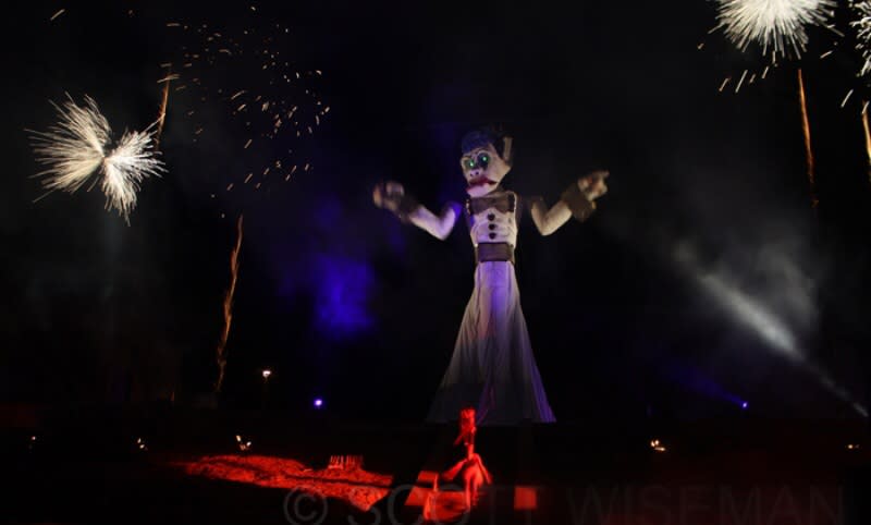 Each year the Firedancer (seen below) taunts and teases Zozobra, much to the crowds delight. (Courtesy of The Burning of Will Schuster’s Zozobra.)