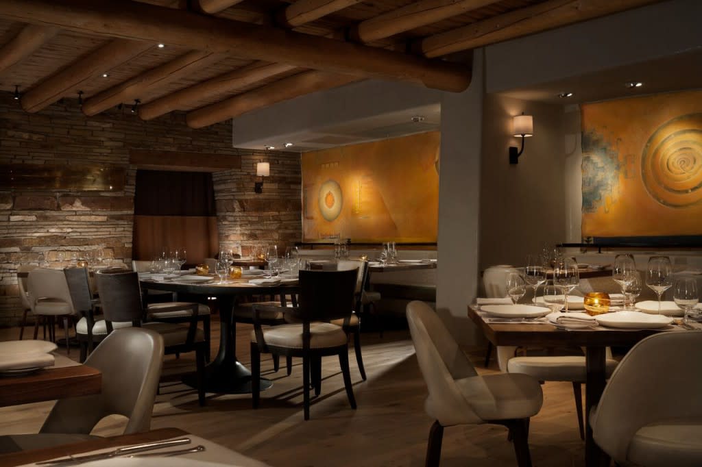 The 40-seat dining room offers guests an intimate dining experience with a sophisticated design featuring leather and linen chairs complementing the natural wood tables. Photo courtesy of Rosewood Inn of the Anasazi.