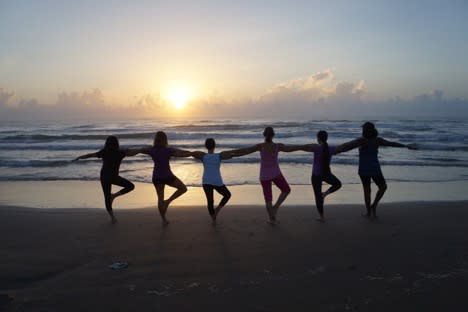 crane pose sunset beach