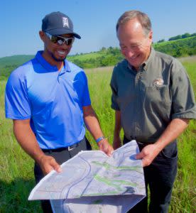 Tiger Woods and Johnny Morris look over plans for the new golf course.