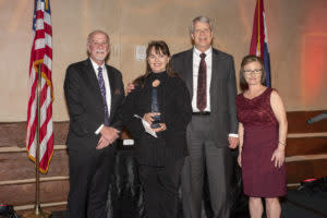 Tracy Kimberlin (left) and Stephanie Hein (right) presented the Pinnacle Award to Rick McQueary and Mary Haseltine McQueary.