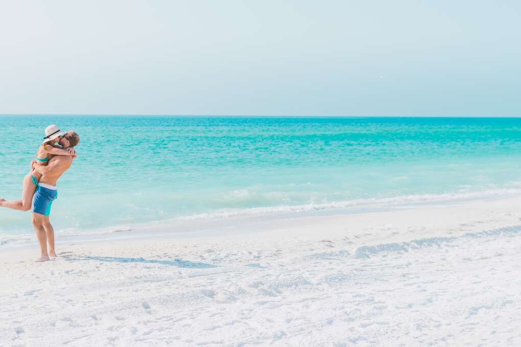 A couple's romantic getaway on the white sand shores of Anna Maria Island