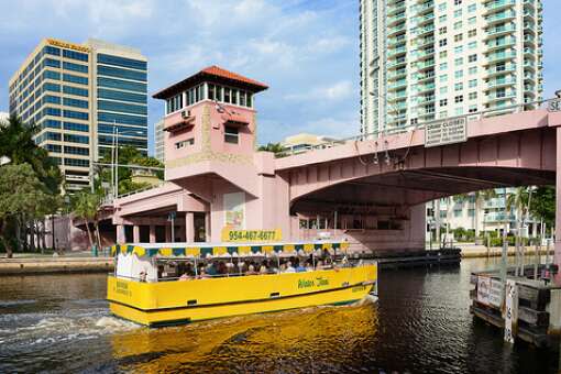 The Water Taxi heads down the New River under the 3rd Avenue Bridge in Fort Lauderdale.