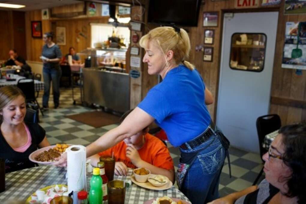 A waitress serves a group pf diners some of the Pioneer Restaurant's homestyle meals in Zolfo Springs, Florida on March 2, 2015. VISIT FLORIDA/Scott Audette