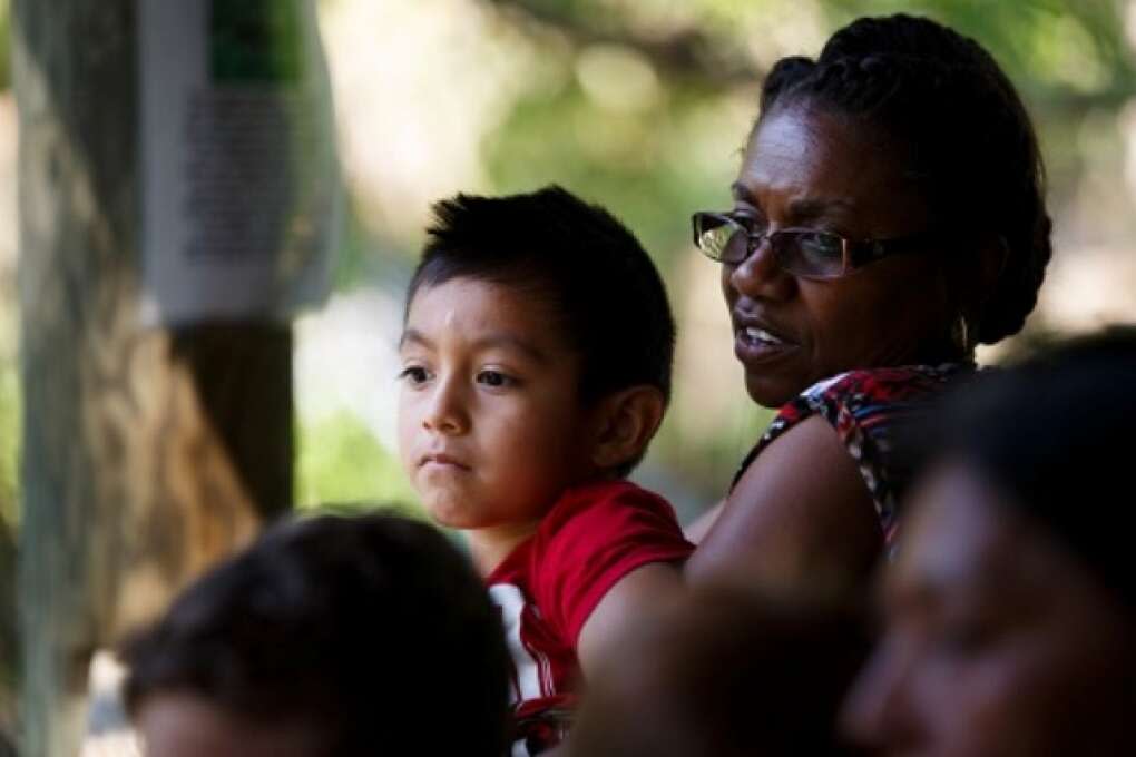 A local pre-schooler assisted by a teacher looks out over the cougar pen at Hardee County Wildlife Refuge in Zolfo Springs, Florida on March 2, 2015. VISIT FLORIDA/Scott Audette