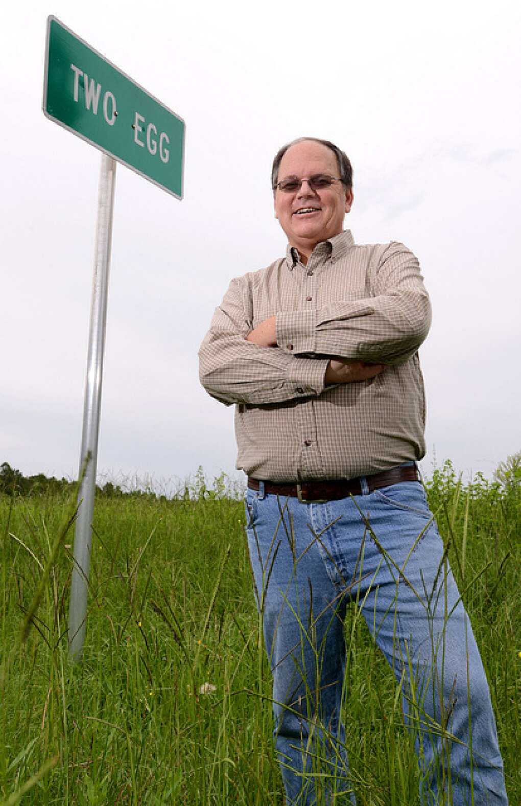 Historian Dale Fox, raised in Two Egg, stands in front of a Two Egg road sign.