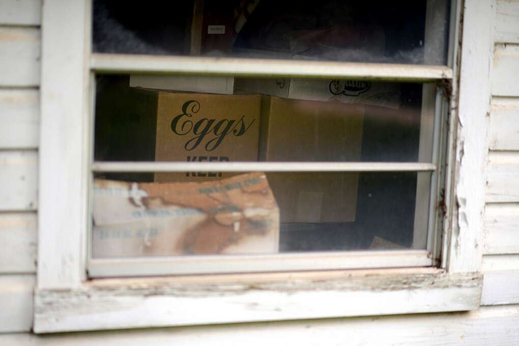 A carton of eggs is seen through the window of the now-closed Lawrence Store in Two Egg.
