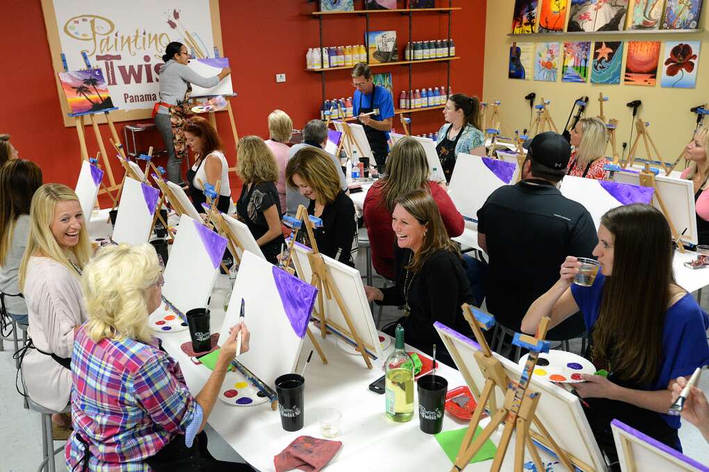 Painters start their canvases and sip wine during class at Painting with a Twist