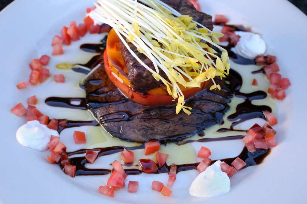 Feast your eyes on this petite filet, with Creekstone Farms beef tenderloin, roasted portobello mushroom, sliced tomatoes, horseradish sauce, and aged balsamic drizzle, served at Mattison's City Grille.