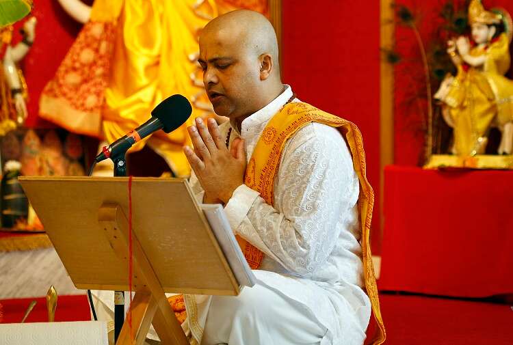 Temple priest Pandit Lal Singh leads Sunday morning prayer service at the Vishnu Mandir in Tampa, which offers hospitality, friendship, and community.
