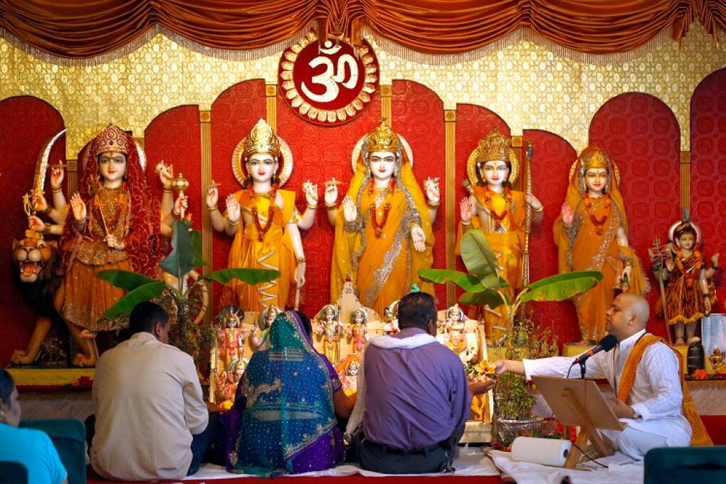 Temple priest Pandit Lal Singh, right, leads Sunday morning prayer service at the Vishnu Mandir in Tampa. According to their web site, the Vishnu Mandir in Tampa provides hospitality, friendship, community and a variety of opportunities for prayer and the study of Hinduism.