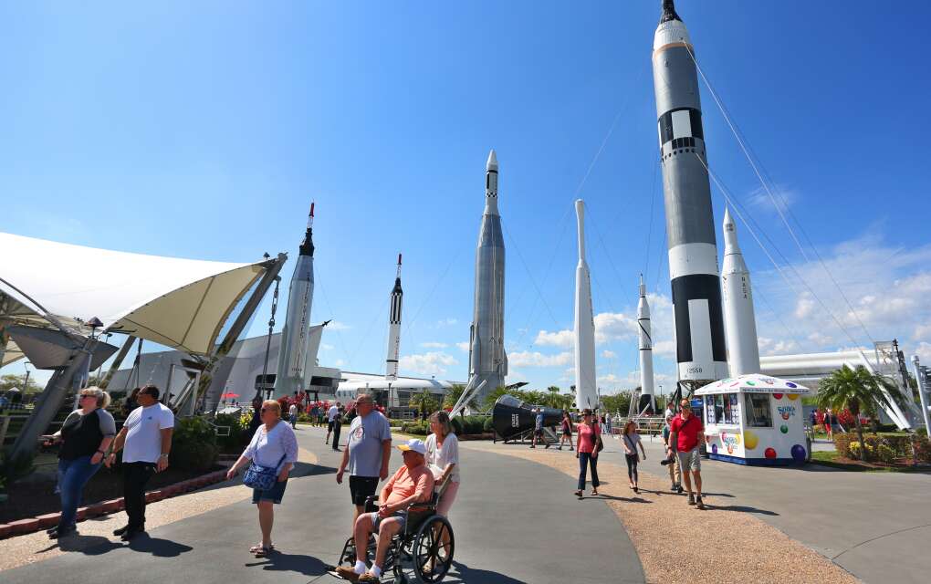 Kennedy Space Center Visitors Center, people viewing attractions, one in a wheel chair. 